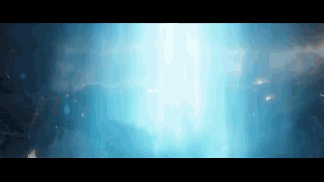 a blue light is coming out of a hole in the ground