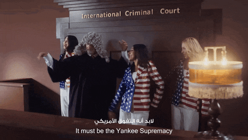 a group of people are standing in front of a sign that says international criminal court