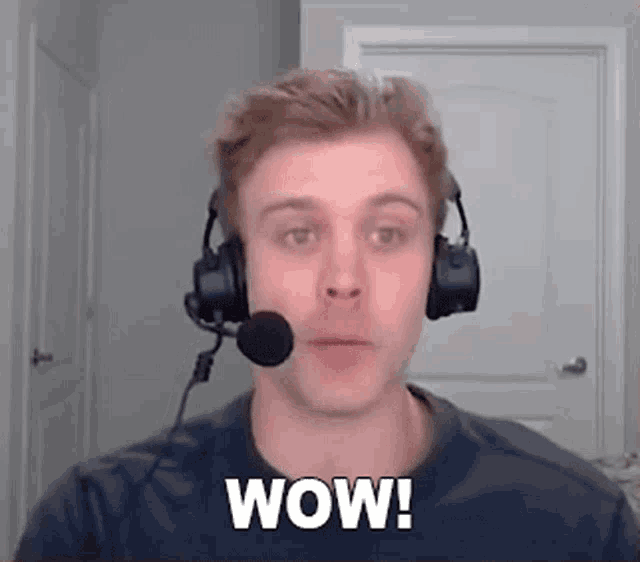 a man wearing headphones and a microphone is saying wow !