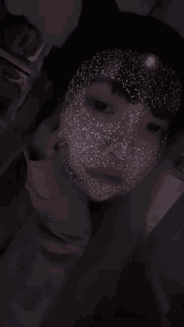 a person with a mask on their face that looks like a starry sky