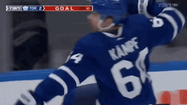 a hockey player wearing a blue jersey with the number 6 on it