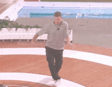 a man standing in front of a pool that says all stars on it
