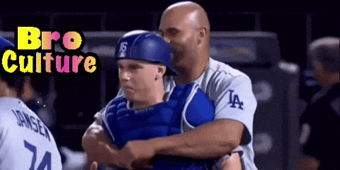 a baseball player with the number 24 on his jersey is hugging another player
