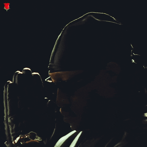a man wearing sunglasses and a black head scarf