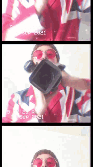 a man in a red white and blue outfit is holding a video camera with the date september 2021 on it