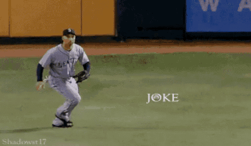 a baseball player catching a ball with the word joke written on the field