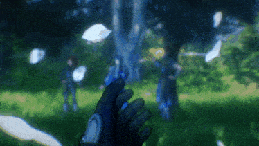 a blurry picture of a person 's hand holding something in a field