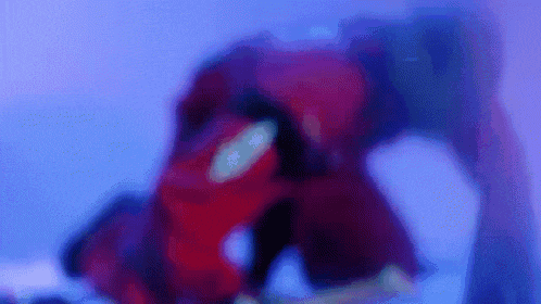 a blurry picture of a person in a red suit in a purple room .