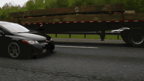 a black car is driving down a highway next to a trailer that says ' ee ' on the side