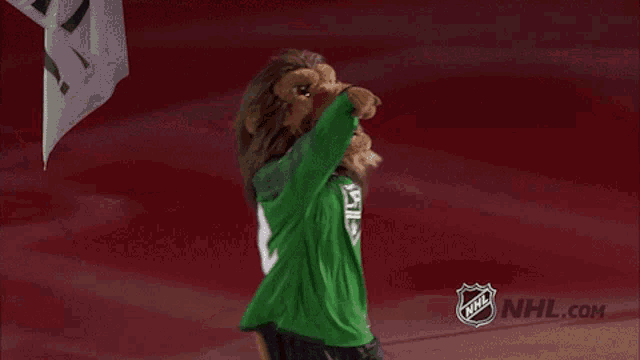 a lion mascot is wearing a green shirt with the number 7 on it
