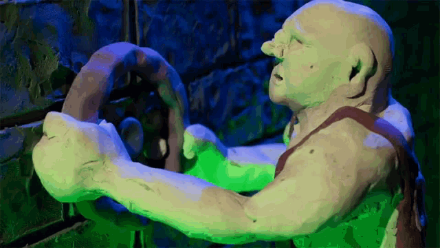 a statue of a man holding a steering wheel in his hand