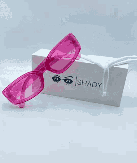 a pair of shady sunglasses sitting on top of a box
