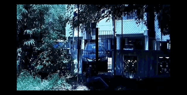 a man in a blue shirt is laying down with his head on the ground