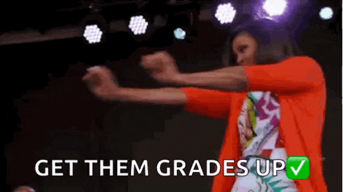 a woman in an orange jacket is dancing on a stage with the words `` get them grades up '' .