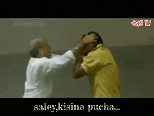 a man in a yellow shirt is slapping another man 's face