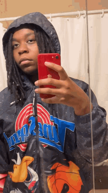 a person taking a selfie with a space jam jacket