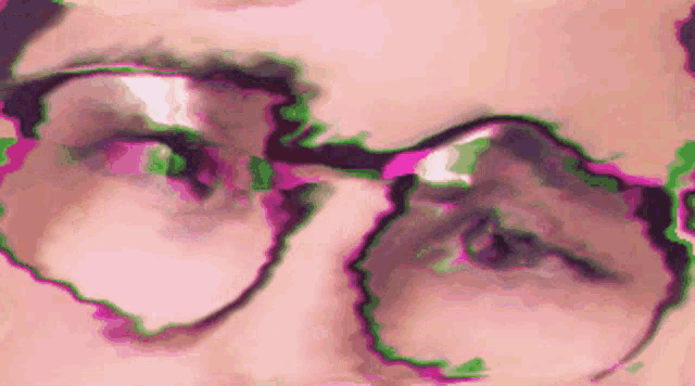 a close up of a person wearing glasses with a pink and green background