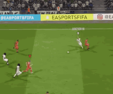 a soccer game is being played on a field with a yellow banner that says easportsfifa