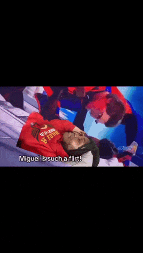 a man in a red suit is talking to another man in a red cape who is saying miguel is such a flirt