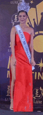 a woman in a red dress is wearing a sash that says " muph muntinlupa "