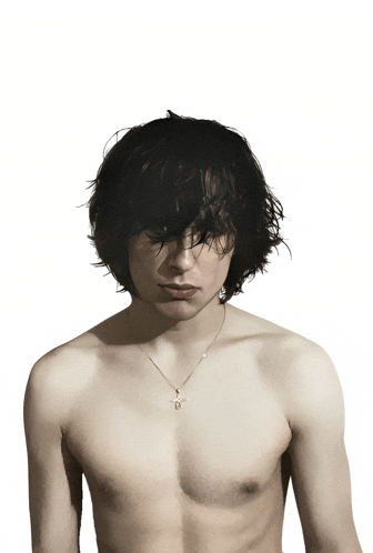 a man without a shirt is wearing a necklace that has the letter b on it