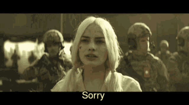 a woman with blonde hair is standing in front of a group of soldiers and says sorry
