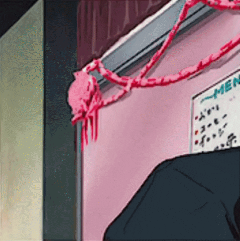 a man is standing in front of a pink wall with a sign that says ramen on it .