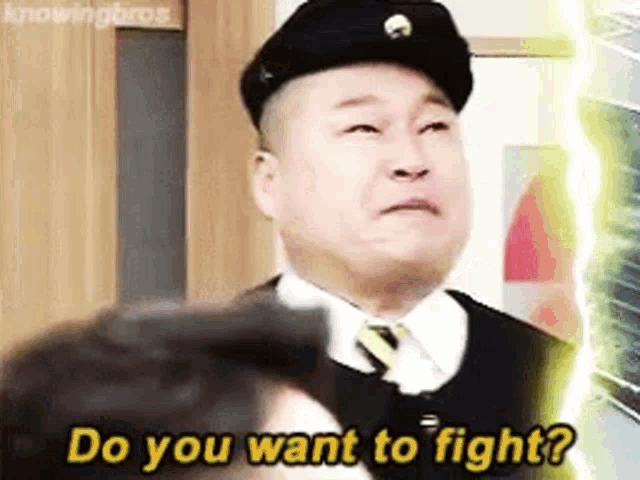 a man wearing a hat and tie is asking if he wants to fight .