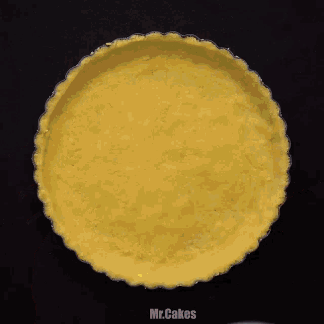 a person is pouring liquid into a pie crust that says mr. cakes on it