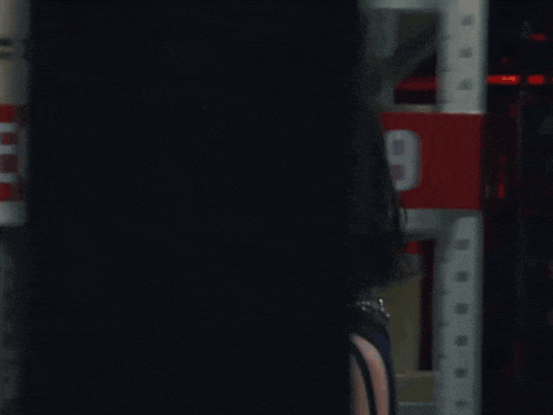 a woman is standing in front of a red sign that says 2