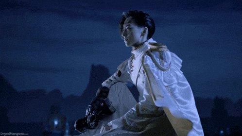 a man in a white cape is holding a gun and the words dryedmangoes.com are visible in the corner