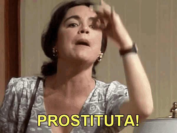 a woman in a gray dress says prostituta with her hand on her forehead