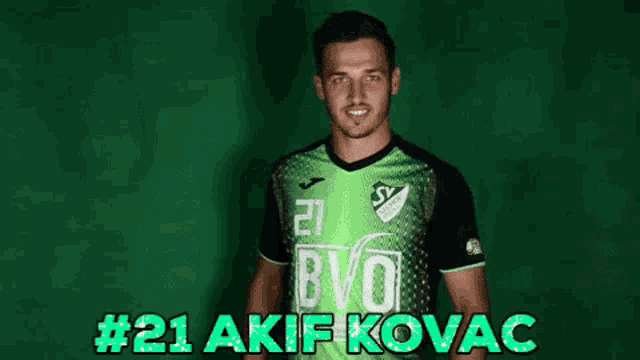 a soccer player wearing a green jersey that says bvo on it