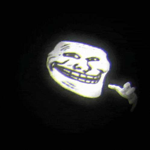 a troll face is being projected in the dark