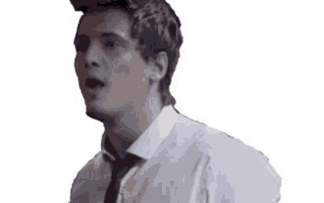 a man in a white shirt and black tie is making a funny face .