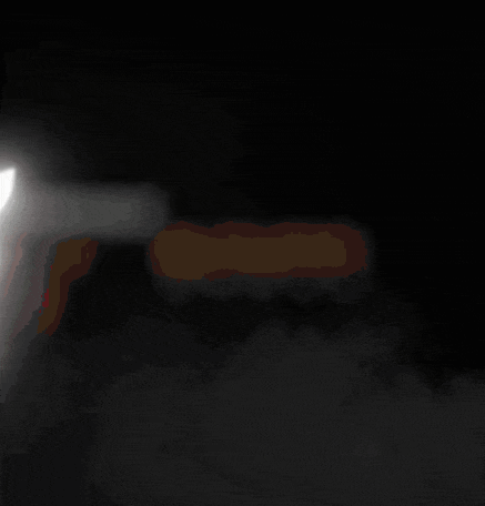 a person standing in a dark room with a light behind them