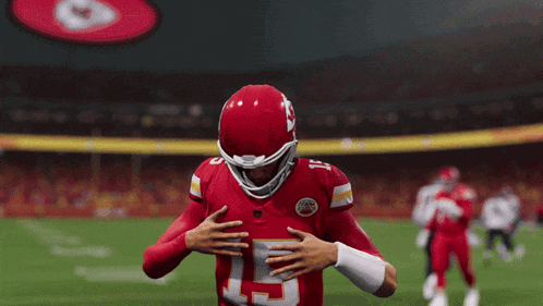 a man in a chiefs jersey is running on a football field