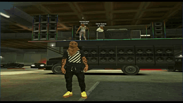 a screenshot of a video game shows a man standing in front of a truck with a dj on it