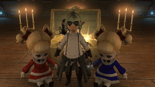 two dolls standing next to each other in front of a chest