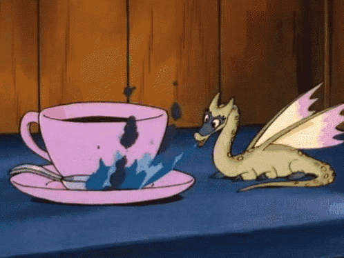 a cartoon dragon is sitting next to a pink cup of coffee