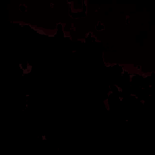 a person is singing into a microphone in a dark room with a red background .
