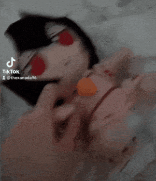 a person is petting a stuffed doll that has red eyes