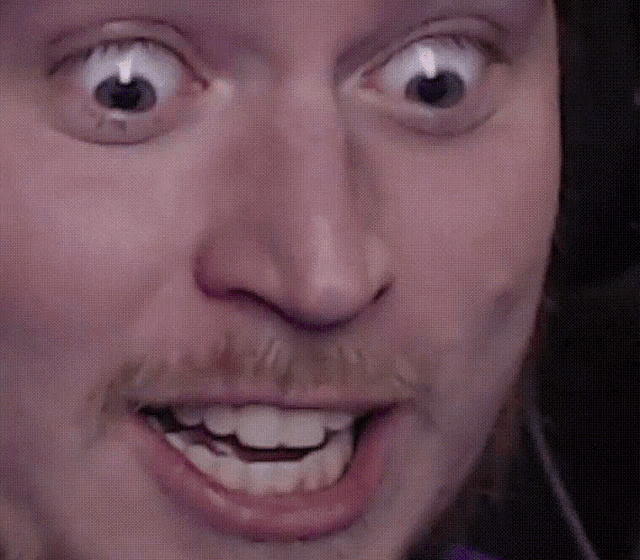 a close up of a man 's face with a beard and mustache