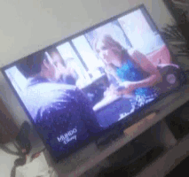 a tv screen shows a man and a woman and says mundo disney