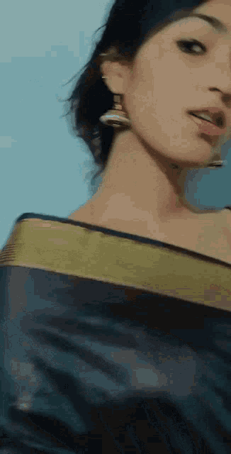 a close up of a woman 's face with earrings on