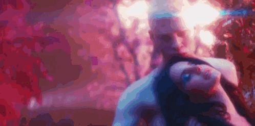 a man and a woman are laying on top of each other in a room .