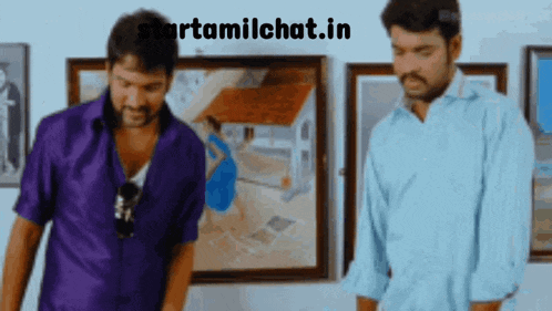 two men standing in front of paintings with the website starttamilchat.in