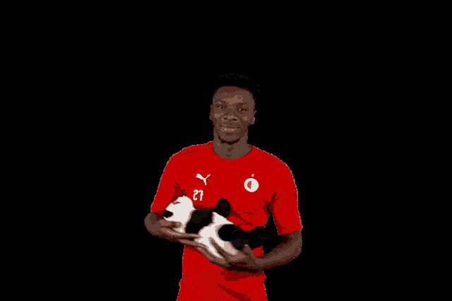 a man in a red shirt has the number 21 on his shirt