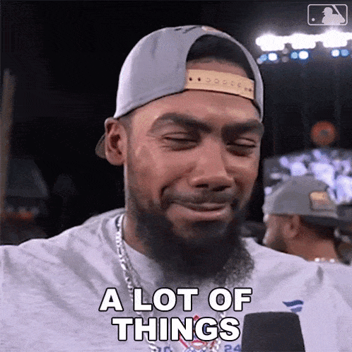 a man with a beard wearing a hat and a shirt that says a lot of things