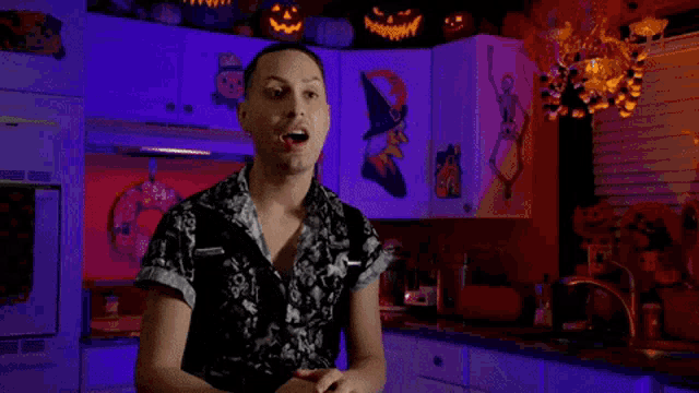 a man in a kitchen with the name victoria black in red